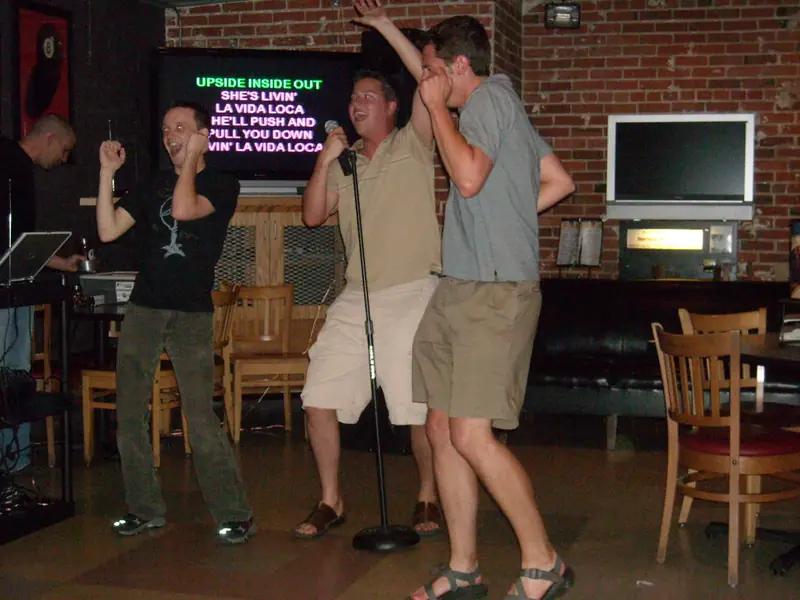 Friends singing karaoke together